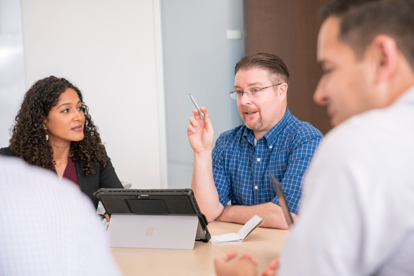 Employees at a meeting table